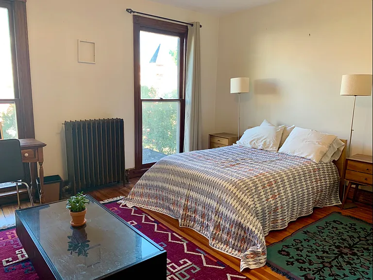 Large bedroom at front of house. Furnishings can include king bed, side tables, lamps. Other furniture not present.