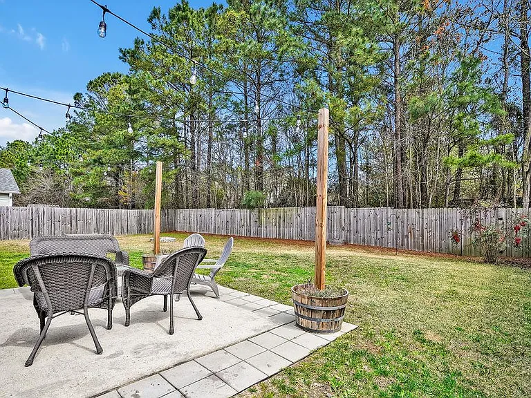 Privacy fenced in backyard and patio. Flower pots with posts and sting lights included.