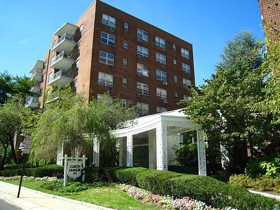 Large sunny living room opens to the "L" shaped dining room. There is a door that leads to a private