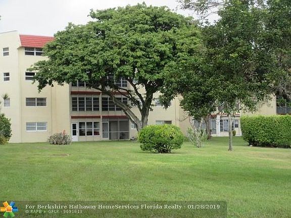 REAR VIEW-CONDO #108 IS THE SECOND PATIO FROM THE LEFT ON THE FIRST FLOOR