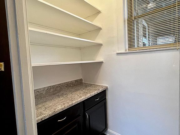 Walk in pantry with door.