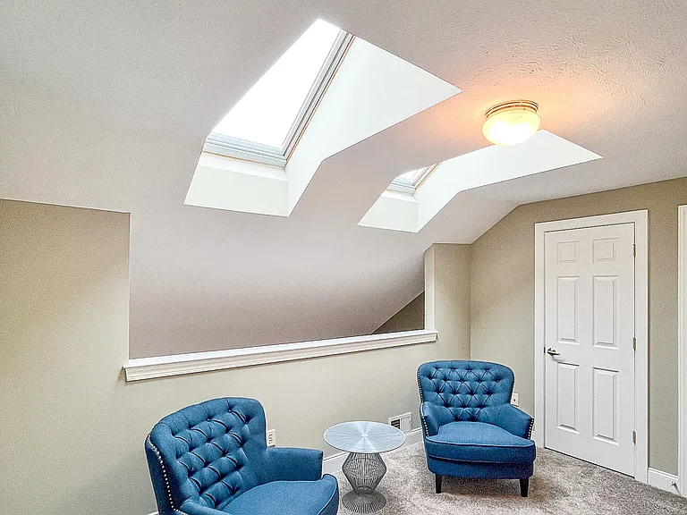 2nd floor loft area with skylights and closets for storage