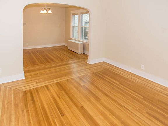 Newly refinished hardwoods in expansive living room and dini