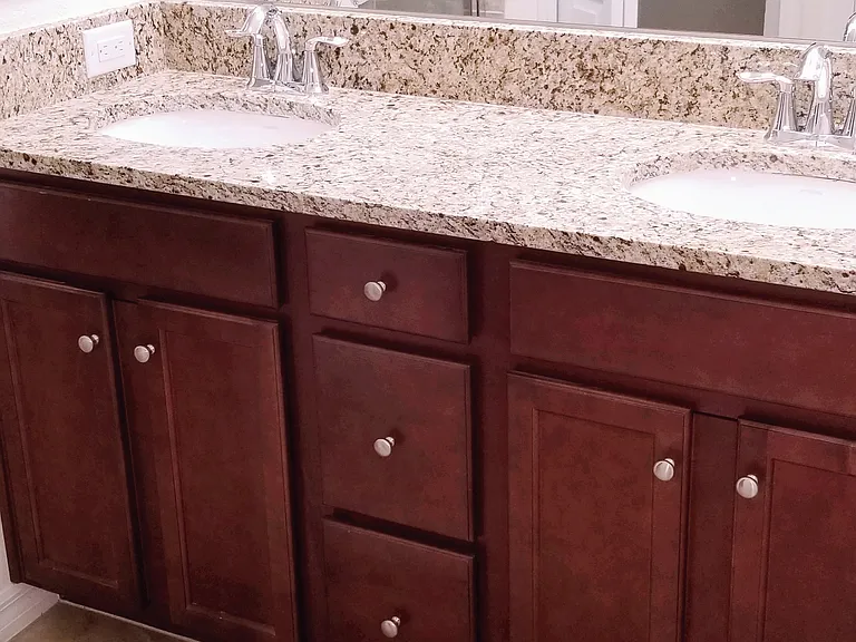 Double sink Vanity and Shower in Master bath with Granite top and Cherry cabinetry