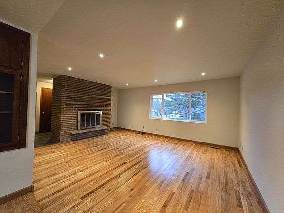 Brick fireplace and media nook in the corner.