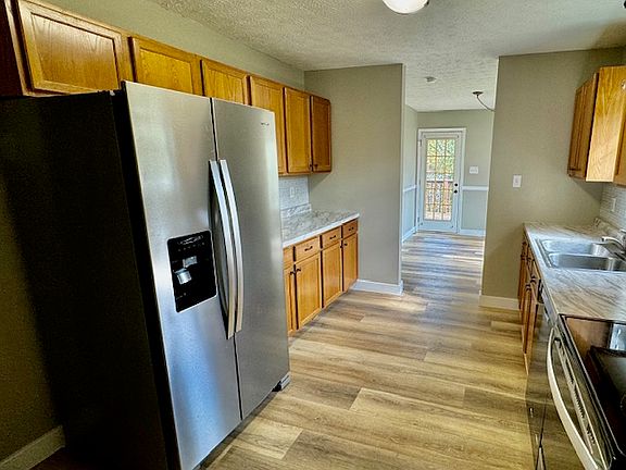 Kitchen with new refrigerator and microwave.