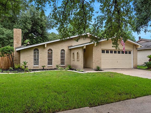 Fresh and mature landscaping surround the home.