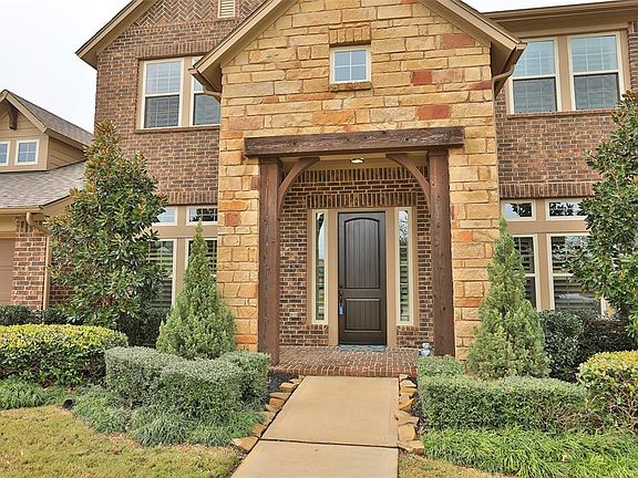 You notice the pretty entrance to the house upon arrival! Beautifully landscaped for great curb appeal! Stone and brick! NO BACK