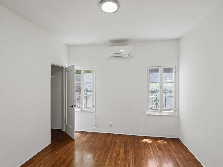 Bedroom with Hardwood Flooring and a Walk-In Closet
