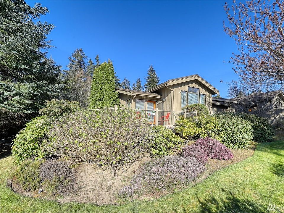 Manicured landscape surrounds the home. 