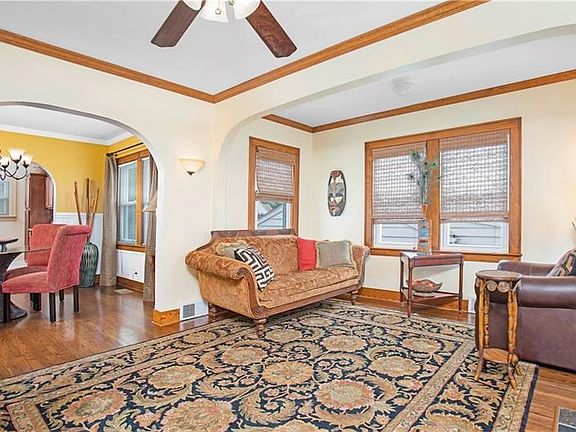 Another view of LIVING ROOM featuring its arched doorways and woven blinds. Leads right in to the dining room.  Great taste!