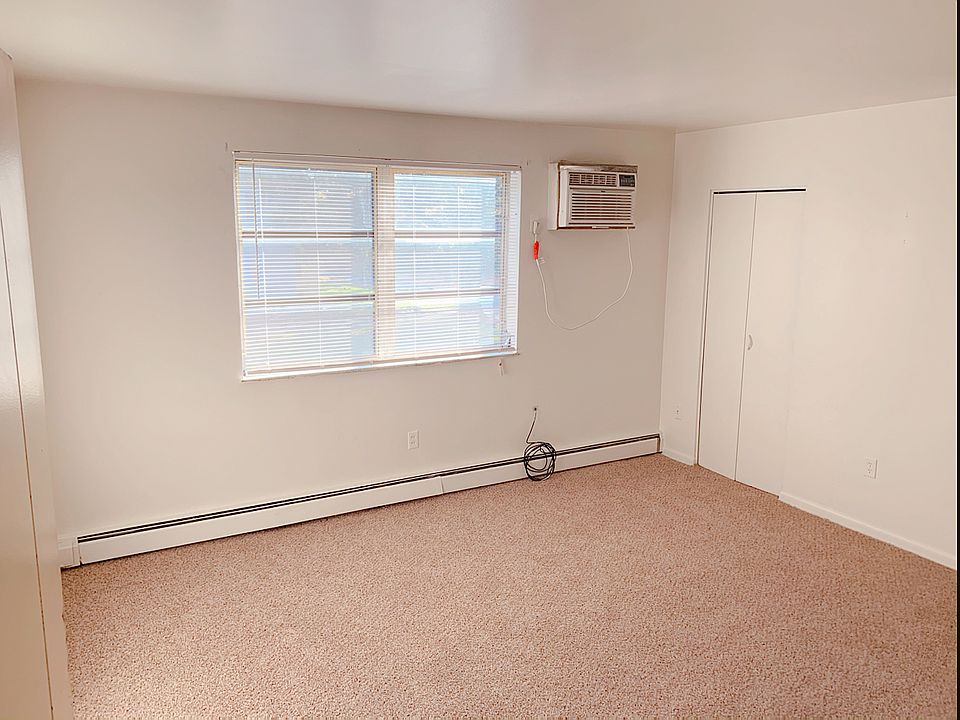 Living room 13 X 14 with closet, A/C window unit & baseboard heating.