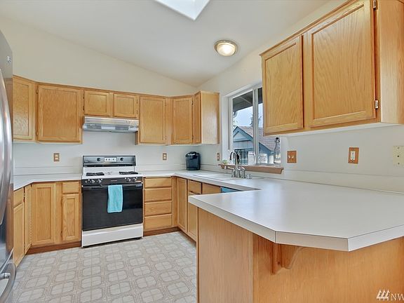 The kitchen is light and bright! Living Room is Open to Kitchen (1/2 wall to the right), Take a few steps down to the Living Room.