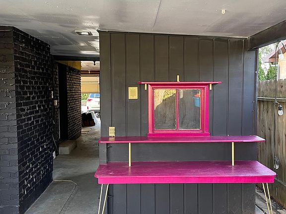 Built-in potting bench or outdoor bar! The breezeway to the left leads to the garage, a storage locker, a workshop, and a door to the kitchen.