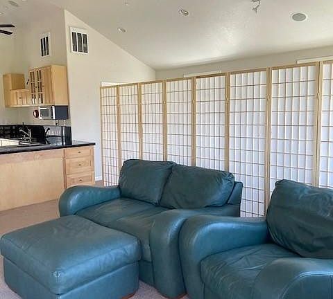 Living and bedroom areas are divided by a translucent 'wall' of natural maple panels