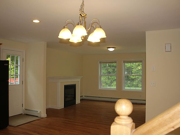 Living room, gas fireplace, side door (photographed from kitchen corner stairway).