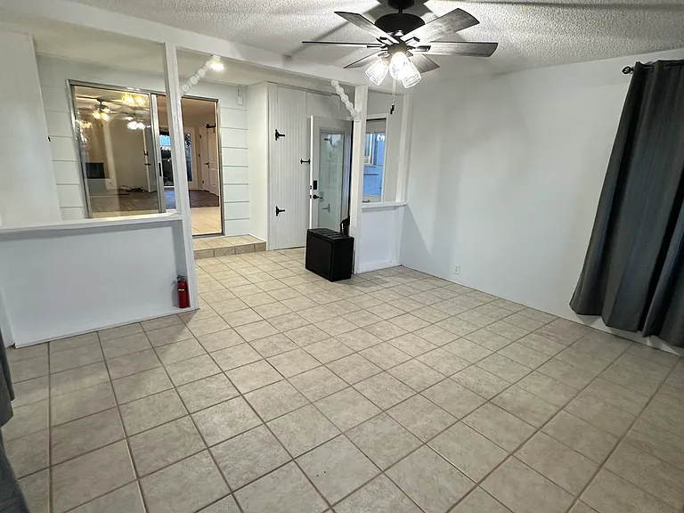 Sum room looking into Dining and Kitchen Living Room areas