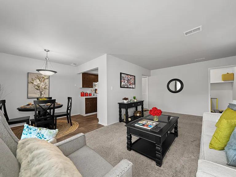 Open and airy living room with natural lighting at Knottingham Apartments in Clinton Township, MI.