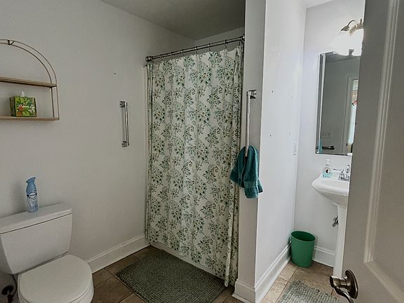 Clean and spacious full bathroom with walk-in shower, fresh linens, and plenty of room to get ready and unwind.