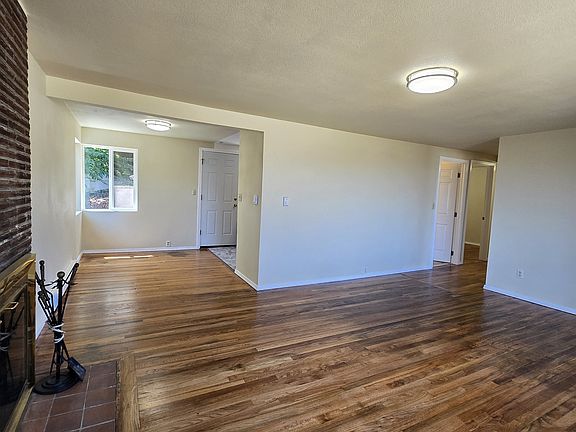Front door to the right of this picture. Looking towards dining space to the left and hallway down to the bedrooms on the right.