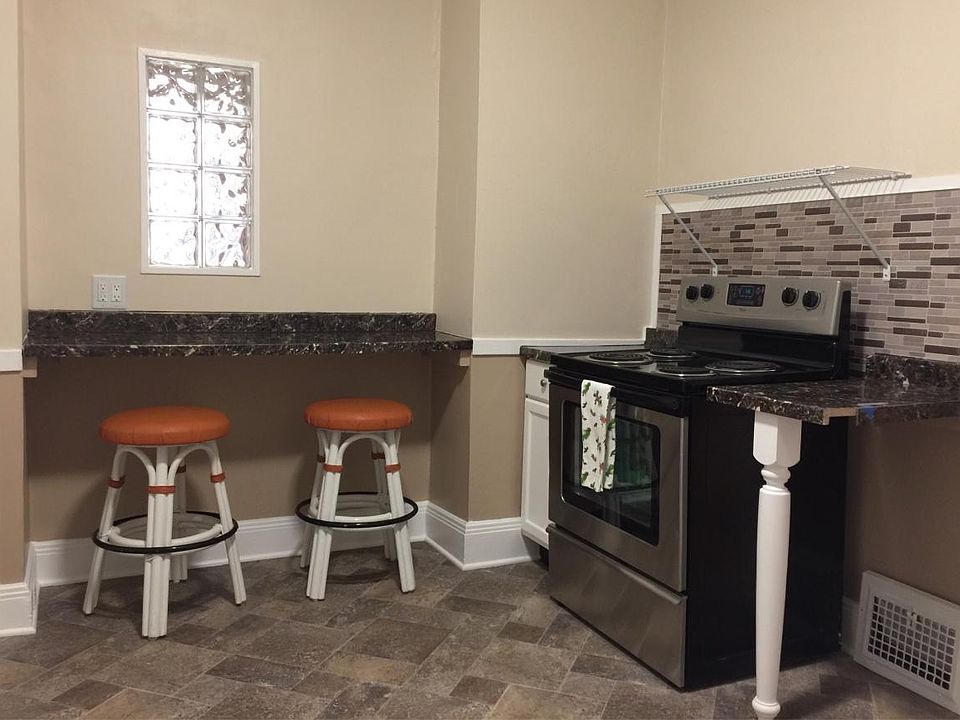 Eat-in kitchen with snack bar and interior glass block window.