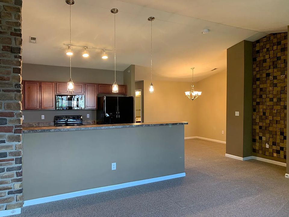 The dining area is right off the kitchen with views into the family room. There is wood decorative wall feature in the family room as well.