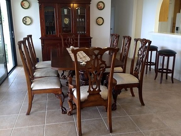 Dining room with kitchen bar on right and sliding glass door to covered lanai on left.