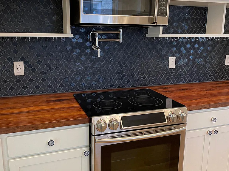 Oven range, microwave, and pot filler over stove