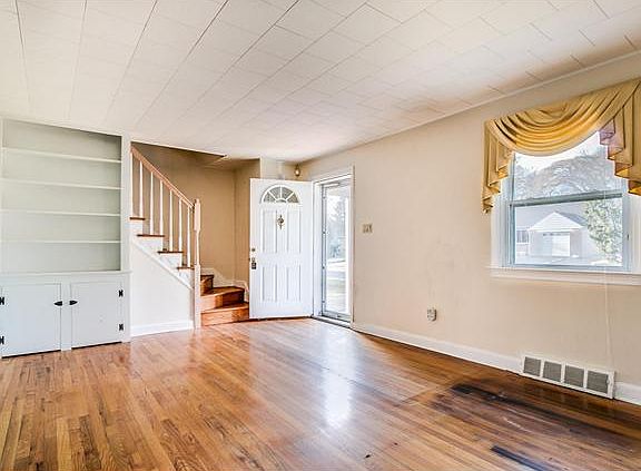 Living room has hardwood floors & built-in cabinet