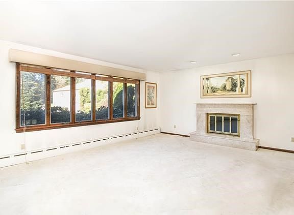 Sunken living room with marble fireplace