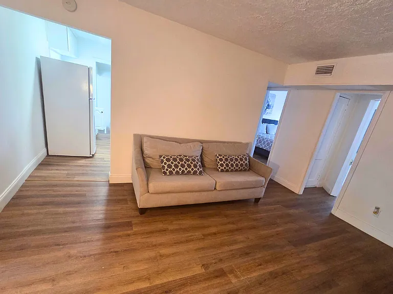 Spacious sofa with decorative pillows for added comfort and relaxation.