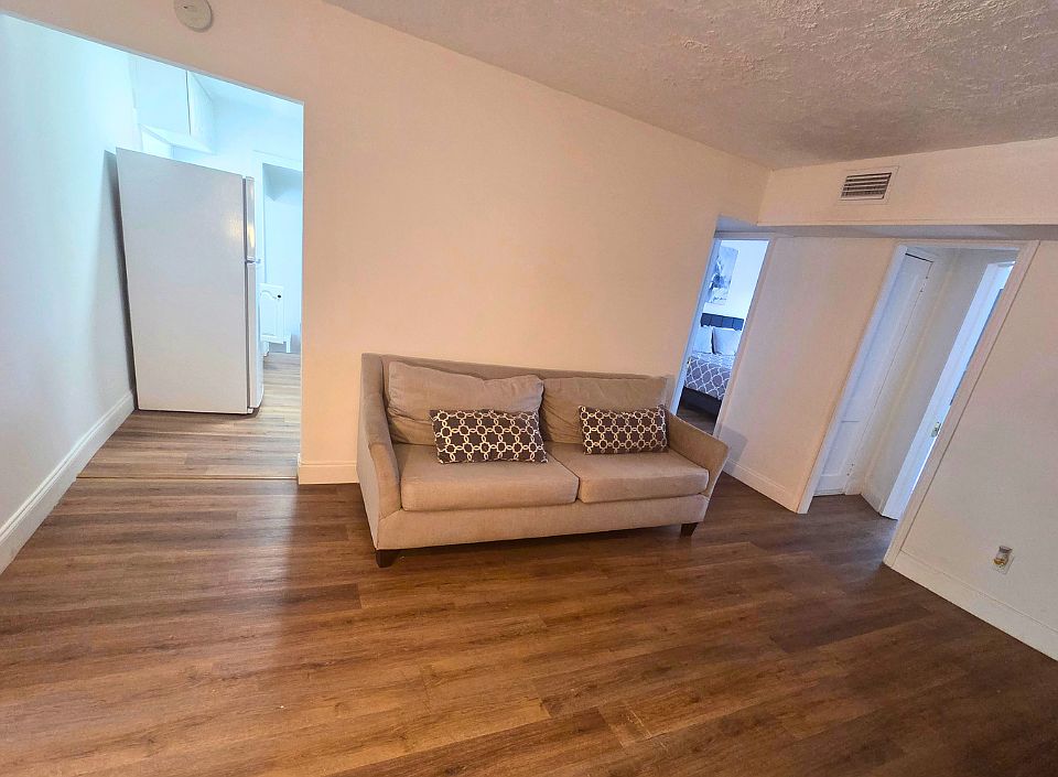 Spacious sofa with decorative pillows for added comfort and relaxation.