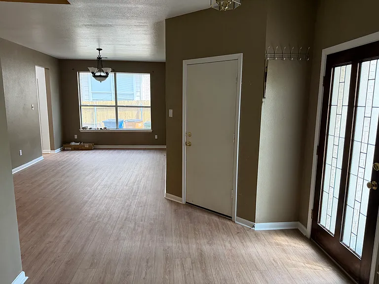 Front Foyer Looking into Dining Room - Entrance to garage visible. Lots of light and high ceilings make the entrance to the home very welcoming.