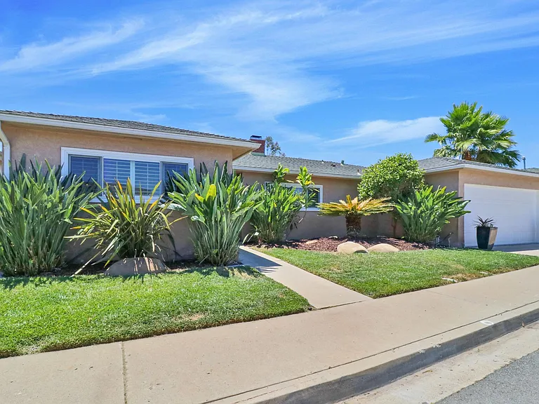 Front of house, including two car garage and ample street parking. (Professional landscape maintenance included)