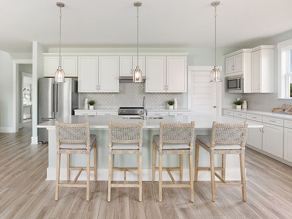 Bright open Kitchen with stunning light pendants.