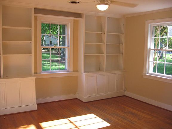 Bedroom with custom shelves and fan