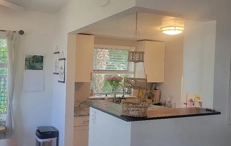 View of breakfast counter and dining area plus windows.