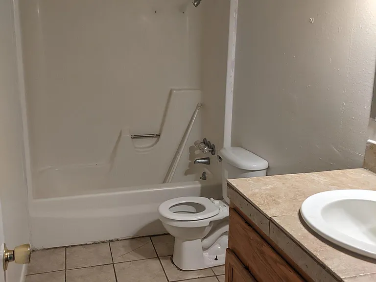 bathroom showing shower, toilet and sink