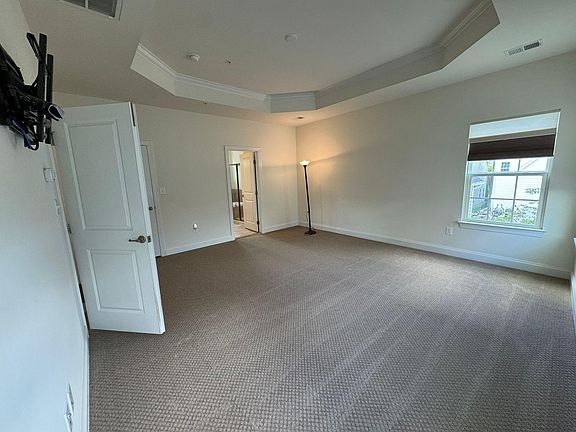 master bedroom with ceiling detailing - brand new carpet, replaced a week ago, attached bathroom