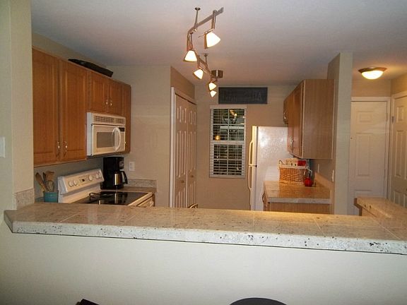 Granite tile counters & breakfast bar for extra seating. Washer & dryer located in kitchen closet..very convenient!