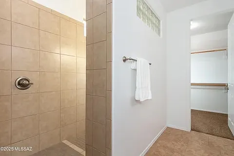 Walk-in shower and closet (in primary bathroom)