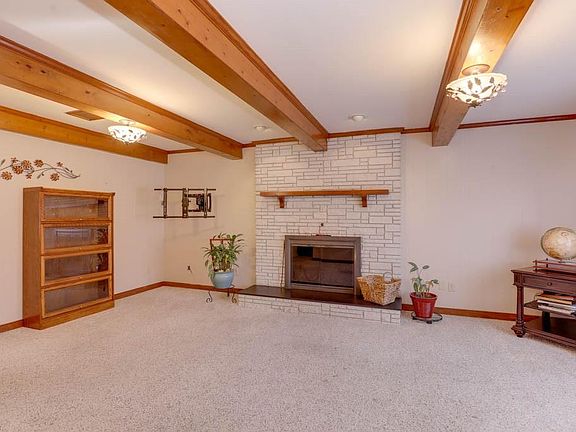 Family room - original ceiling beams & Wood FP adds comfort & coziness 