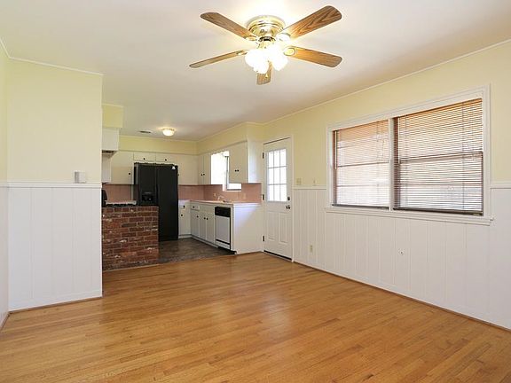 Looking fron dining area toward kitchen. Garage entry is on left and back door is on right.