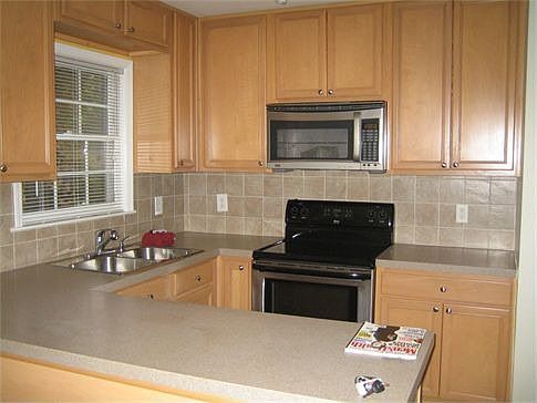 Corian counters and stainless steel appliances (comes with washer and dryer set, too!).
