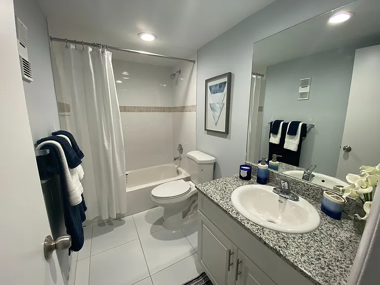 Granite Countertops with Modern, White Plywood Cabinetry With Self-Closing Hinges, in select units