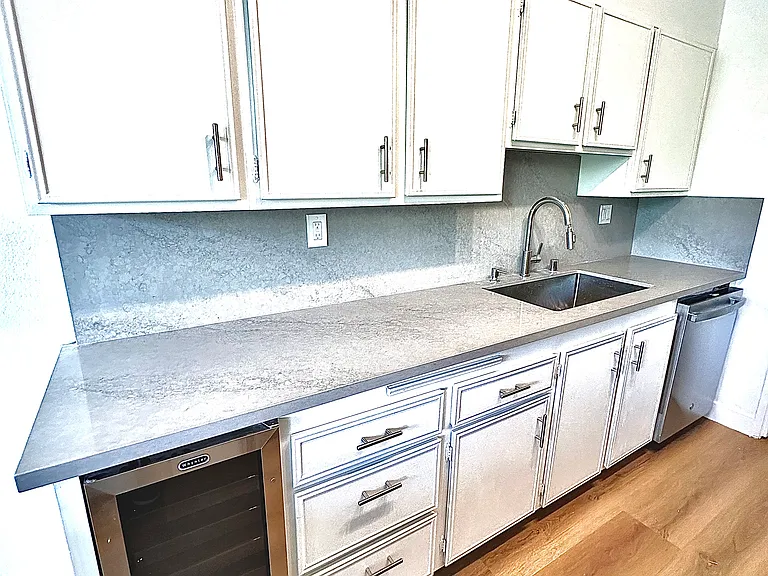 Unit #302 gorgeous brand new quartzite countertops/backsplash and wine refrigerator!
