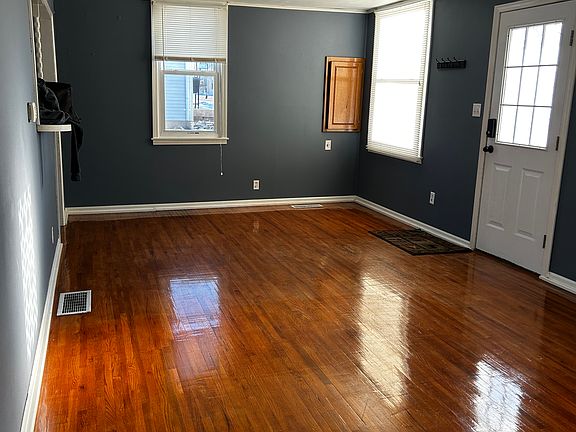 Large living room with original hardwood floors.
