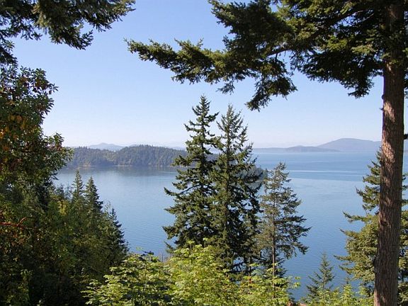 Incredible saltwater views and sunsets are framed by mature evergreens