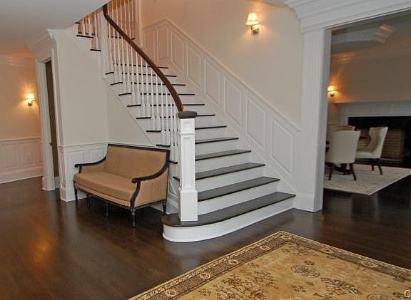 Rich staircase w/raised panels is a focal point inthis gracious