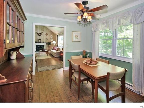 Formal dining room with new hickory flooring, freshly painted, sunnyand leads to newer eat-in-kitche